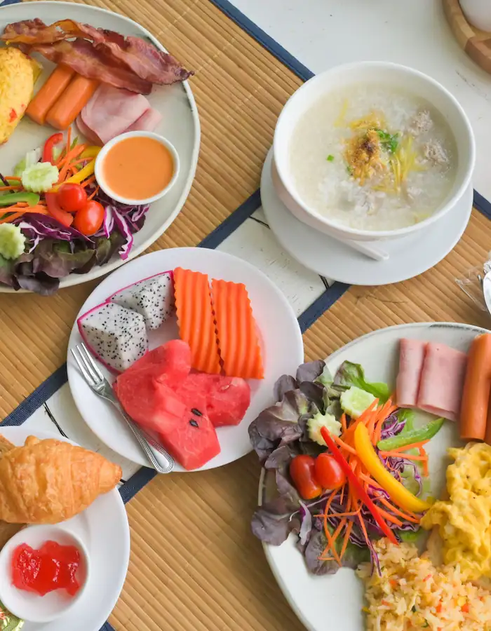 A delicious and colorful breakfast spread with fruits, pastries, and main dishes.